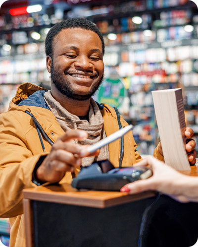 Man paying for a book with his phone